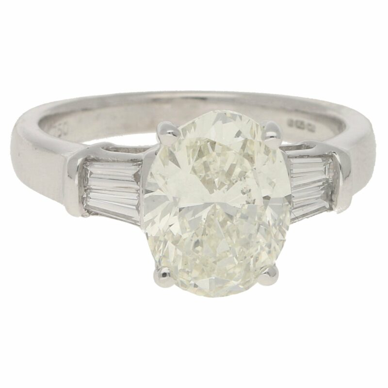 Oval-cut diamond solitaire ring with baguette diamond shoulders