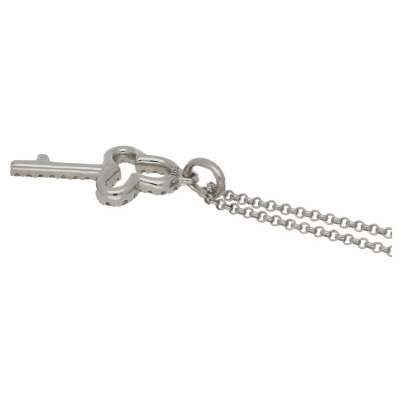 An 18ct white gold diamond set key pendant on a chain