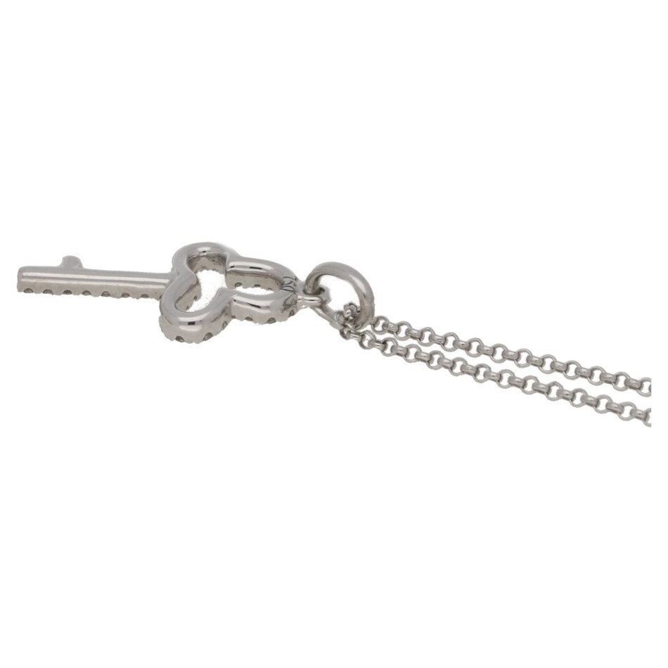 An 18ct white gold diamond set key pendant on a chain