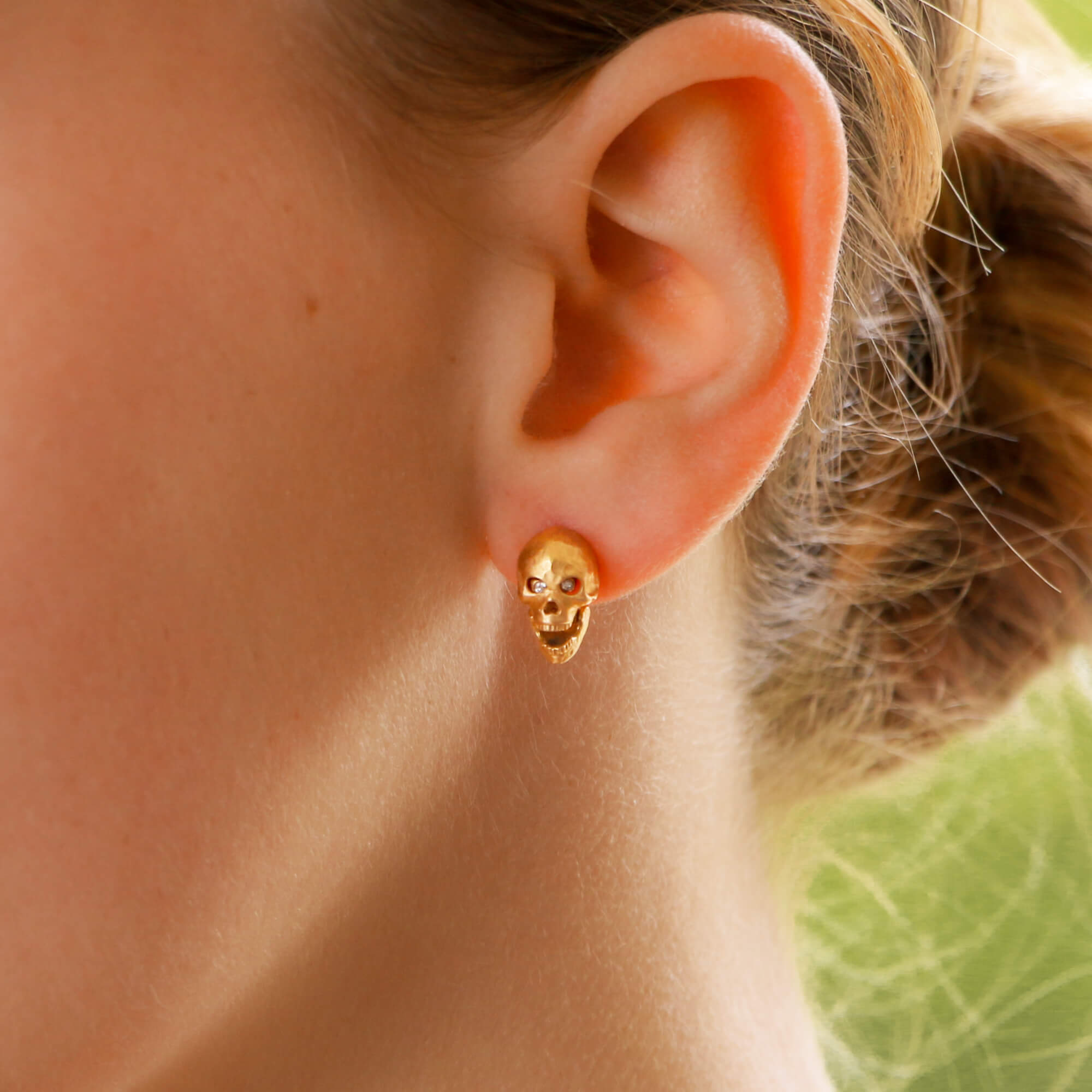 Gold skull shop stud earrings