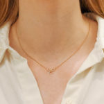 18ct rose gold diamond set bow pendant on a chain