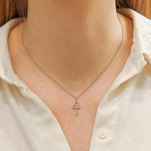 An 18ct white gold diamond set key pendant on a chain