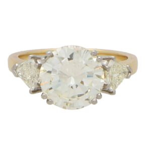 Contemporary Round Brilliant Cut Diamond and Shield Cut Ring