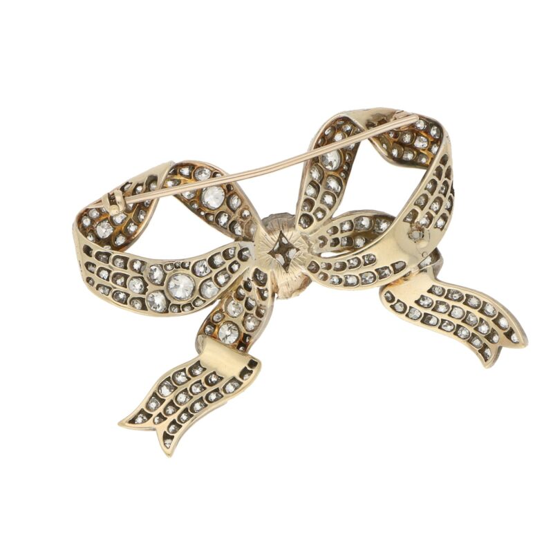 Victorian diamond bow brooch in silver and yellow gold.