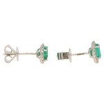 Emerald and diamond cluster earrings in 18K white gold.