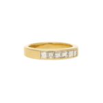 Half diamond eternity ring in 18k yellow gold.