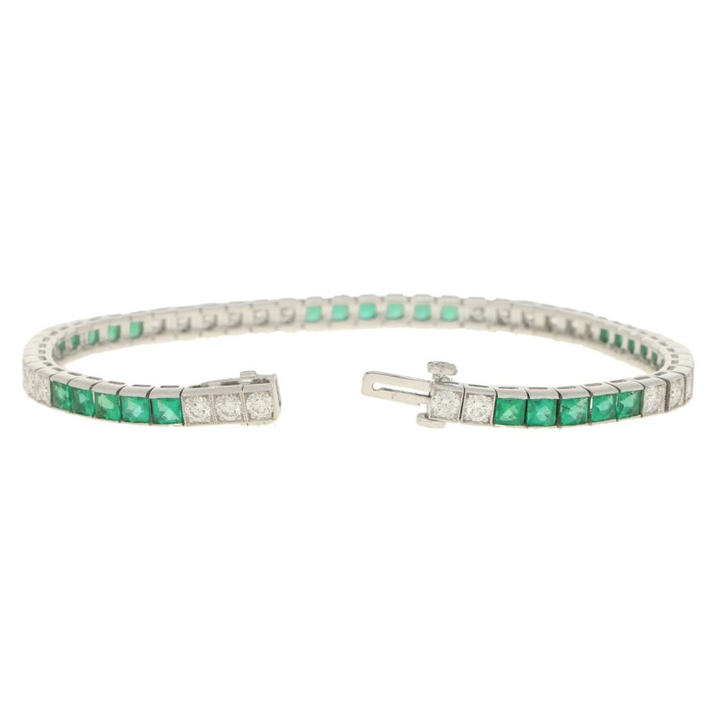 Platinum diamond and emerald line bracelet