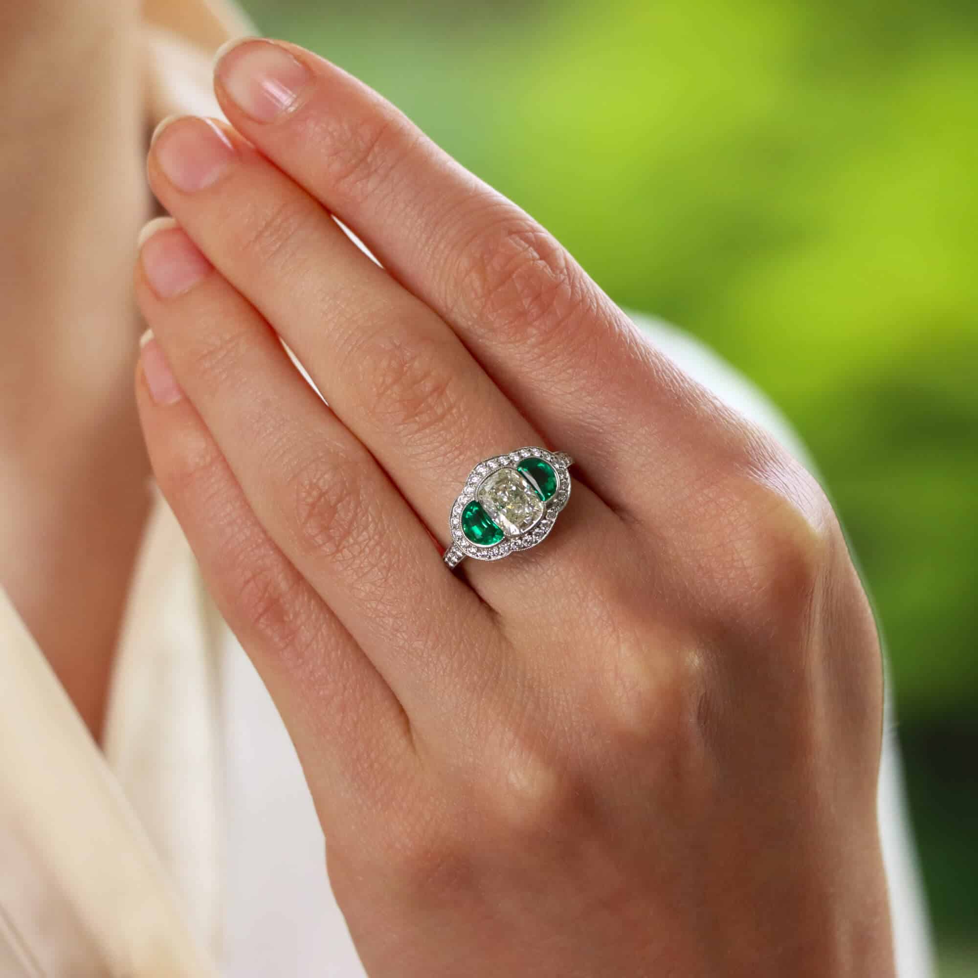 Oval diamond with emerald side stones deals