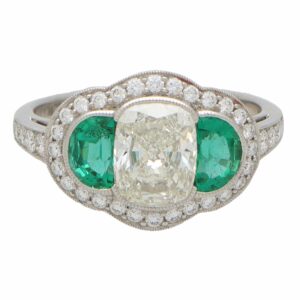 Art Deco Inspired Oval Diamond and Emerald Haloed Three Stone