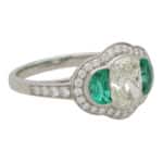 Art Deco Inspired Oval Diamond and Emerald Haloed Three Stone