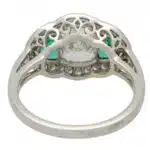 Art Deco Inspired Oval Diamond and Emerald Haloed Three Stone