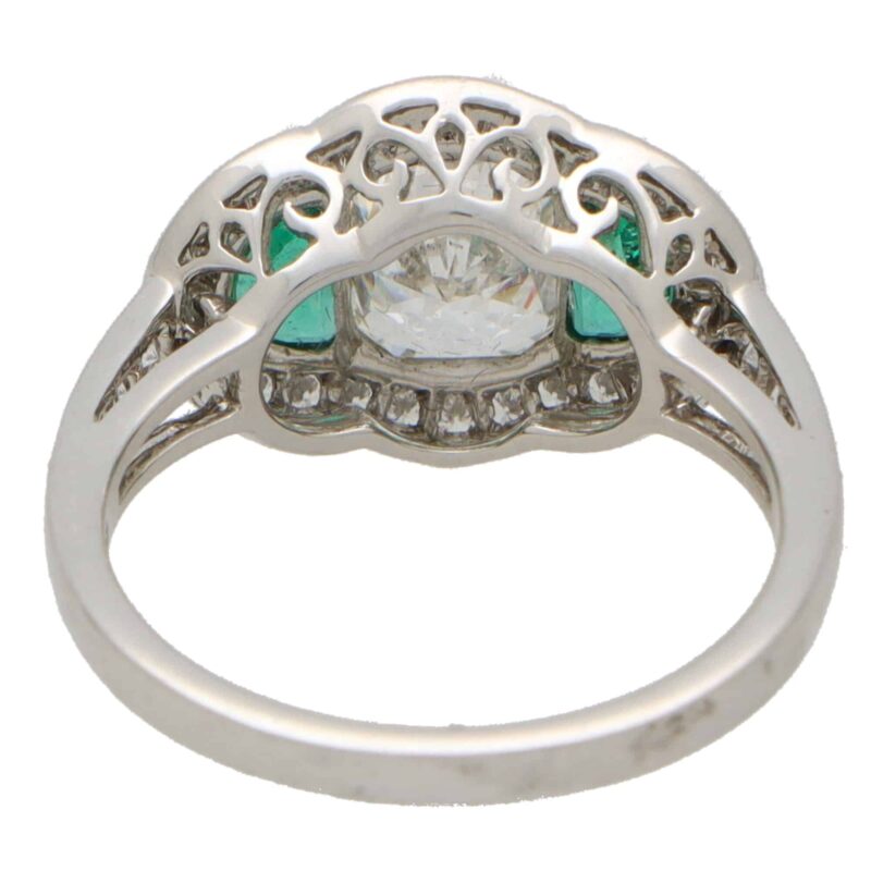 Art Deco Inspired Oval Diamond and Emerald Haloed Three Stone