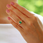 Contemporary Oval Emerald and Round Cute Diamond Three Stone