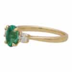 Contemporary Oval Emerald and Round Cute Diamond Three Stone