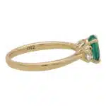 Contemporary Oval Emerald and Round Cute Diamond Three Stone