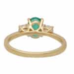 Contemporary Oval Emerald and Round Cute Diamond Three Stone