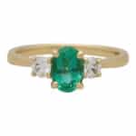 Contemporary Oval Emerald and Round Cute Diamond Three Stone