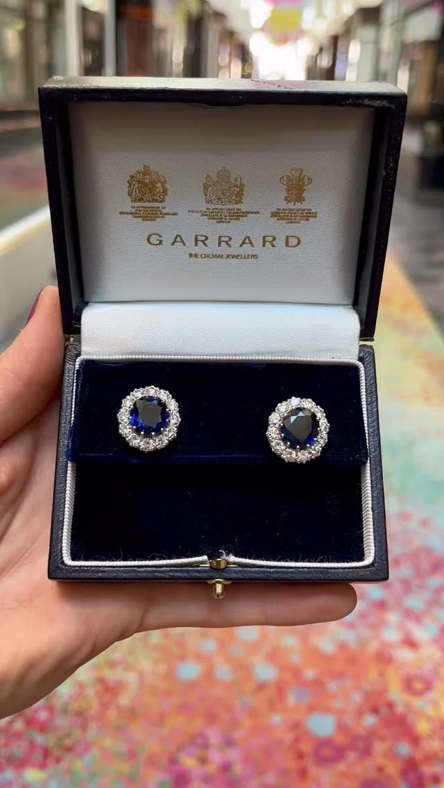 A breathtaking pair of 1990s Garrard sapphire and diamond cluster earrings set in 18k white and yellow gold.

Each earring depicts a floral cluster motif centrally set with a deep blue sapphire a surrounded by 12 round brilliant cut diamonds. 
The total weight of the sapphires is estimated at 8.64 carats. Complemented by 2.4 carats of G-H, VVS-VS diamonds. 

#susannahlovis #susannahlovisjewelry #susannahlovisjewellery #garrard #garrardearrings #sapphire #sapphireanddiamondearrings #sapphireanddiamond #vintagejewelry